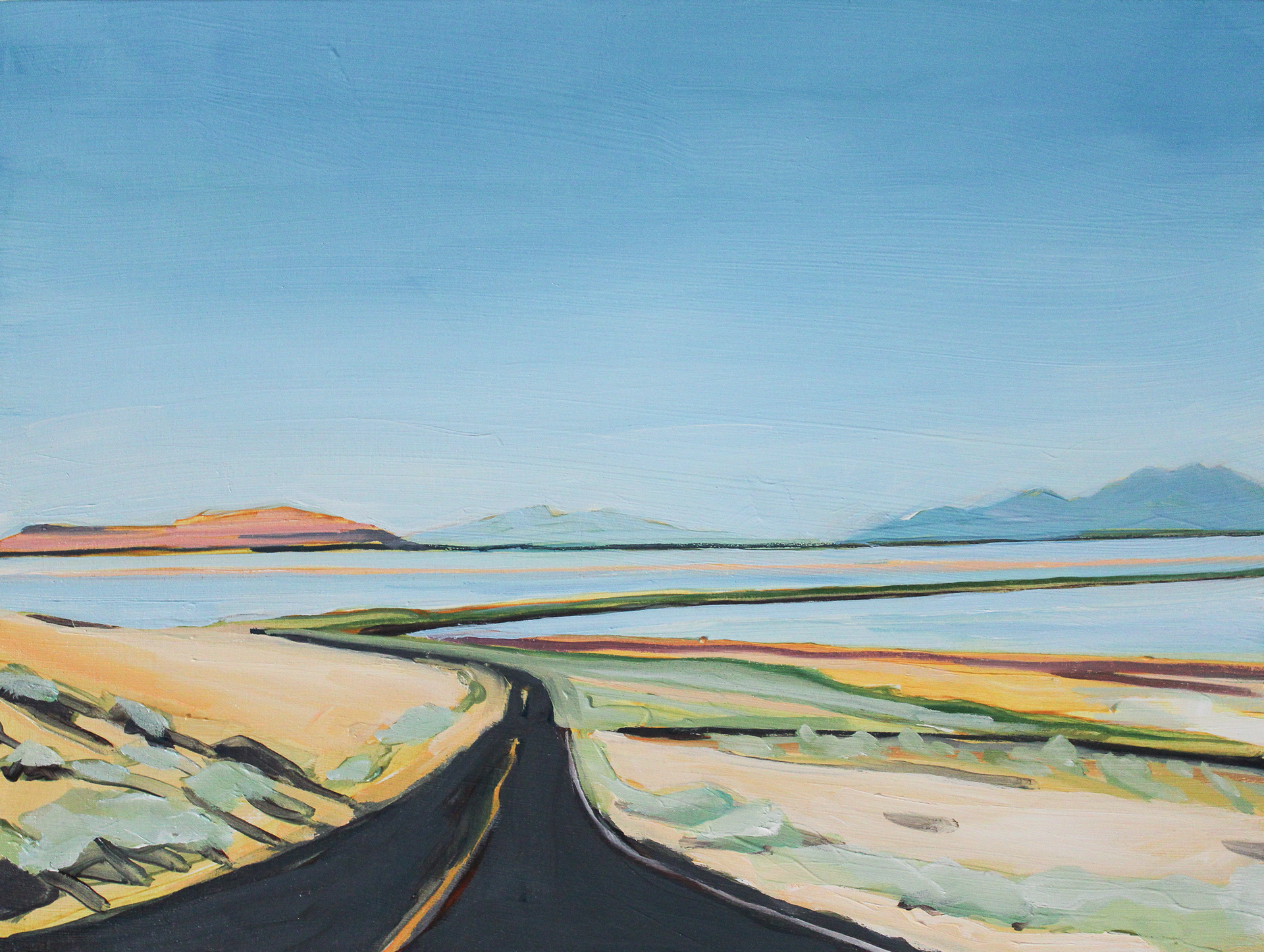 road extending into distance a bridge over water mountains far away